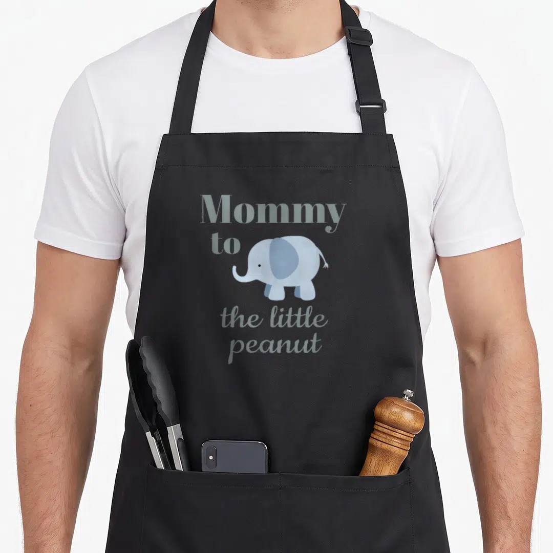 Baby couple apron - Light blue cartoon elephant with Mommy to the little peanut text — shown on a black cotton canvas apron against a white background