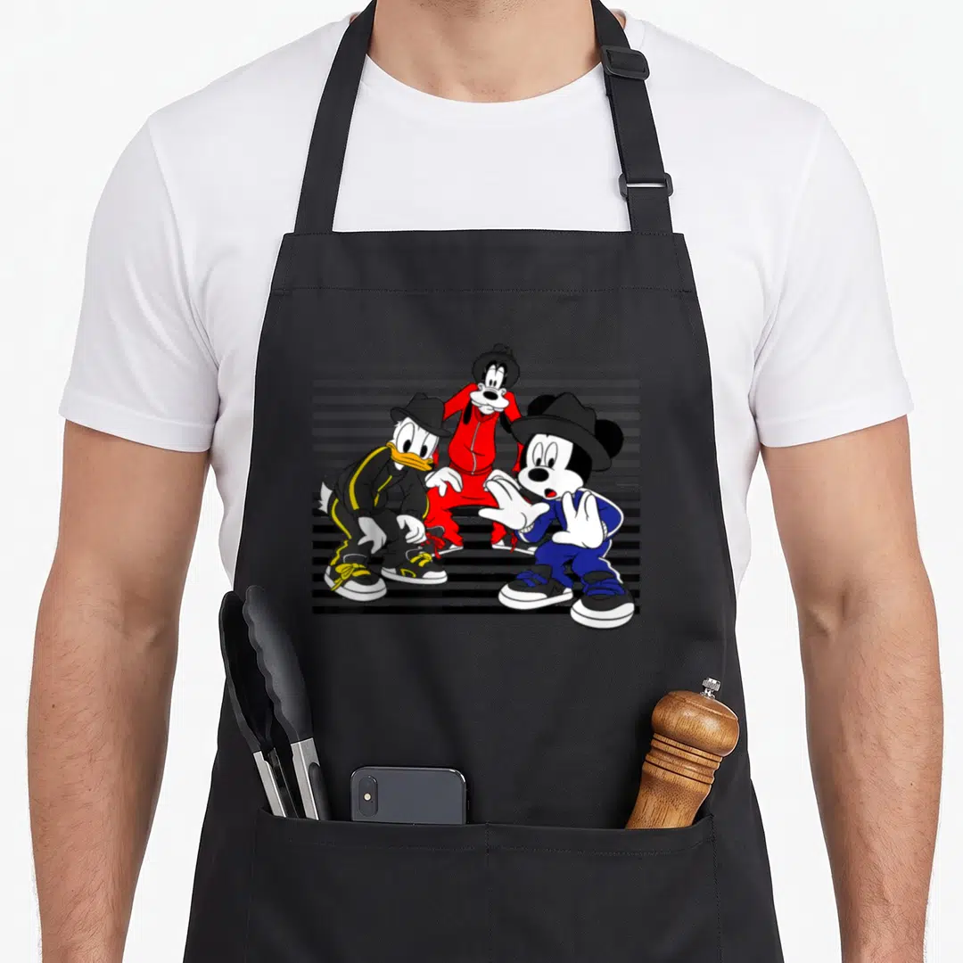 Donald street apron - Three cartoon characters in red blue and black street wear standing against grey and black stripes — shown on a black cotton canvas apron against a white background