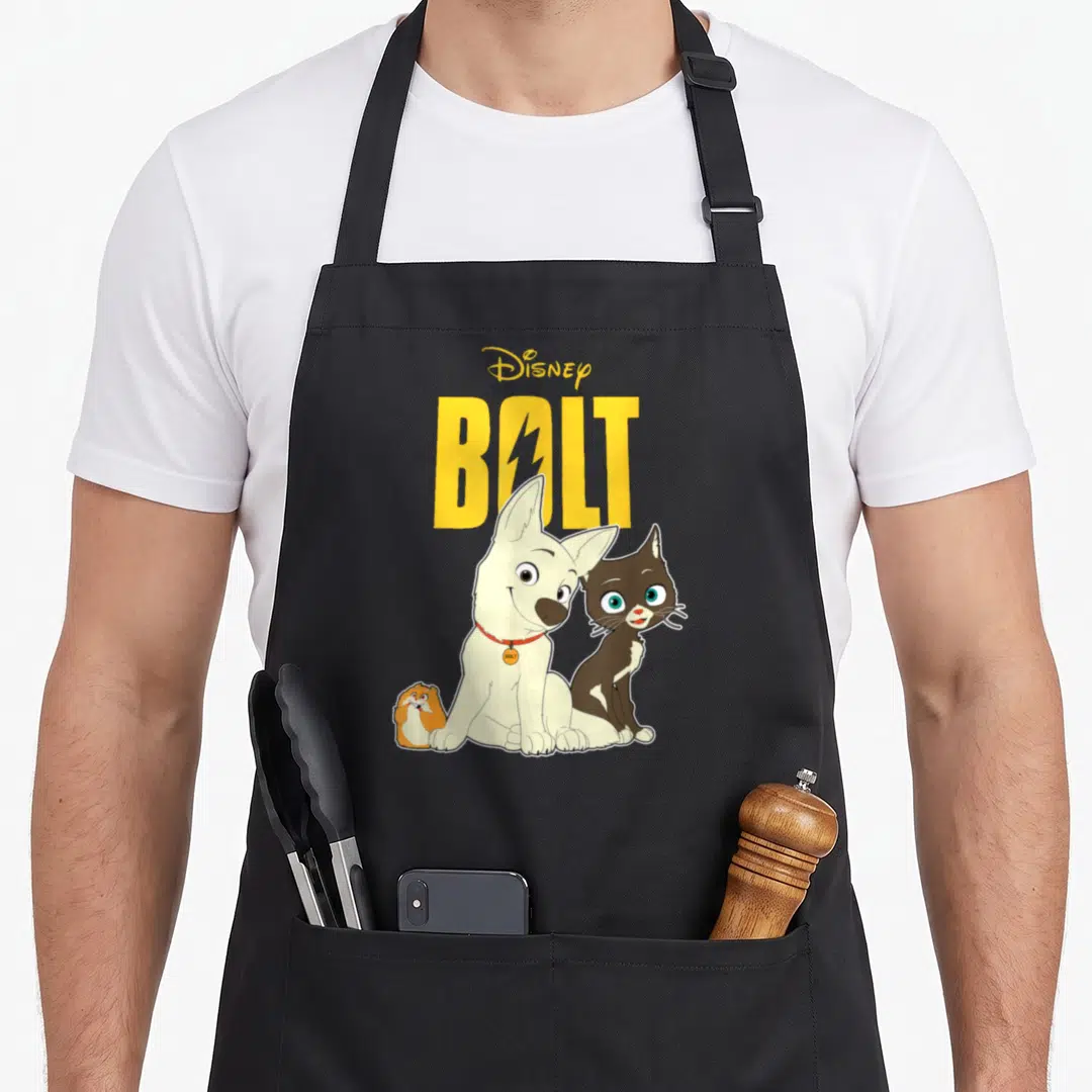 Bolt friends apron - Yellow Disney Bolt text above white dog, brown cat, and orange hamster cartoon — shown on a black cotton canvas apron against a white background