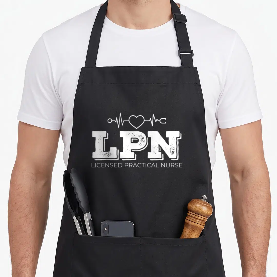 Lpn heartbeat nurse apron - White LPN text with heartbeat line and heart graphic above Licensed Practical Nurse title — shown on a black cotton canvas apron against a white background