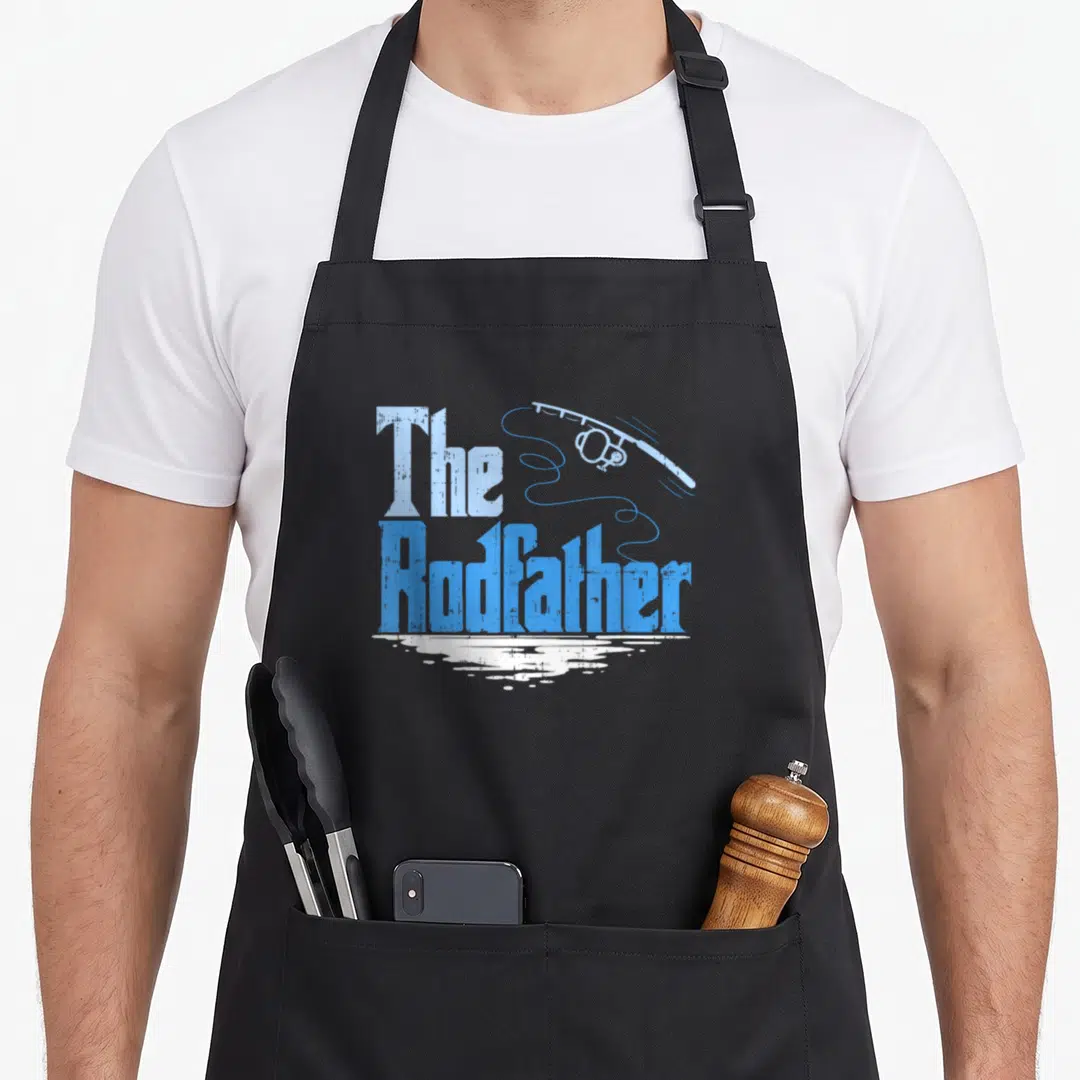 Rodfather fishing apron - Distressed blue text The Rodfather with fishing rod and white water reflection — shown on a black cotton canvas apron against a white background