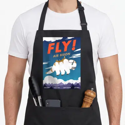 Bison airline apron - Retro poster of Appa flying with FLY! AIR BISON text and four location names below — shown on a black cotton canvas apron against a white background