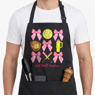 Softball bow apron - Pink bows, yellow softball, brown mitt, crossed bats, and tumbler in a grid layout — shown on a black cotton canvas apron against a white background
