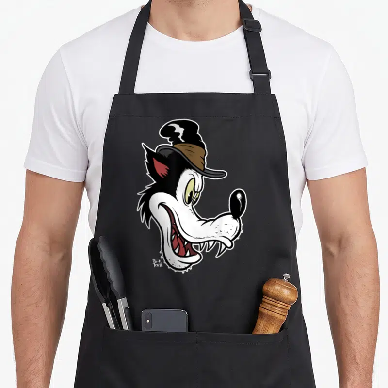 Wolf cartoon apron - Cartoon wolf head wearing a top hat in white black brown and red colors — shown on a black cotton canvas apron against a white background
