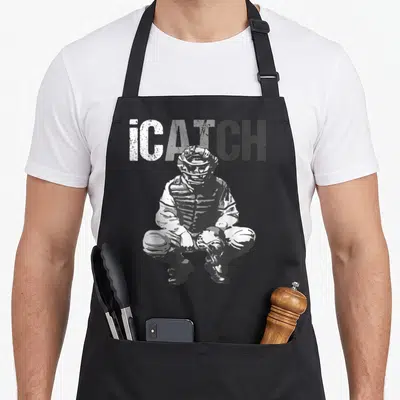 Icatch baseball apron - Distressed iCATCH text above a crouching catcher in grey and white graphics — shown on a black cotton canvas apron against a white background