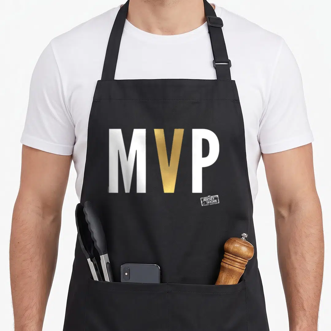 Mvp shore apron - Bold white and gold MVP text with small Jersey Shore Family Vacation logo stamp — shown on a black cotton canvas apron against a white background