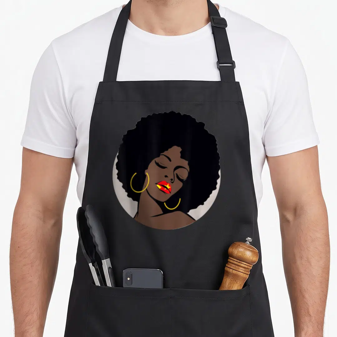 Ethiopian beautiful apron - Minimalist woman with afro, yellow hoops, Tigray flag lips in brown black red yellow — shown on a black cotton canvas apron against a white background