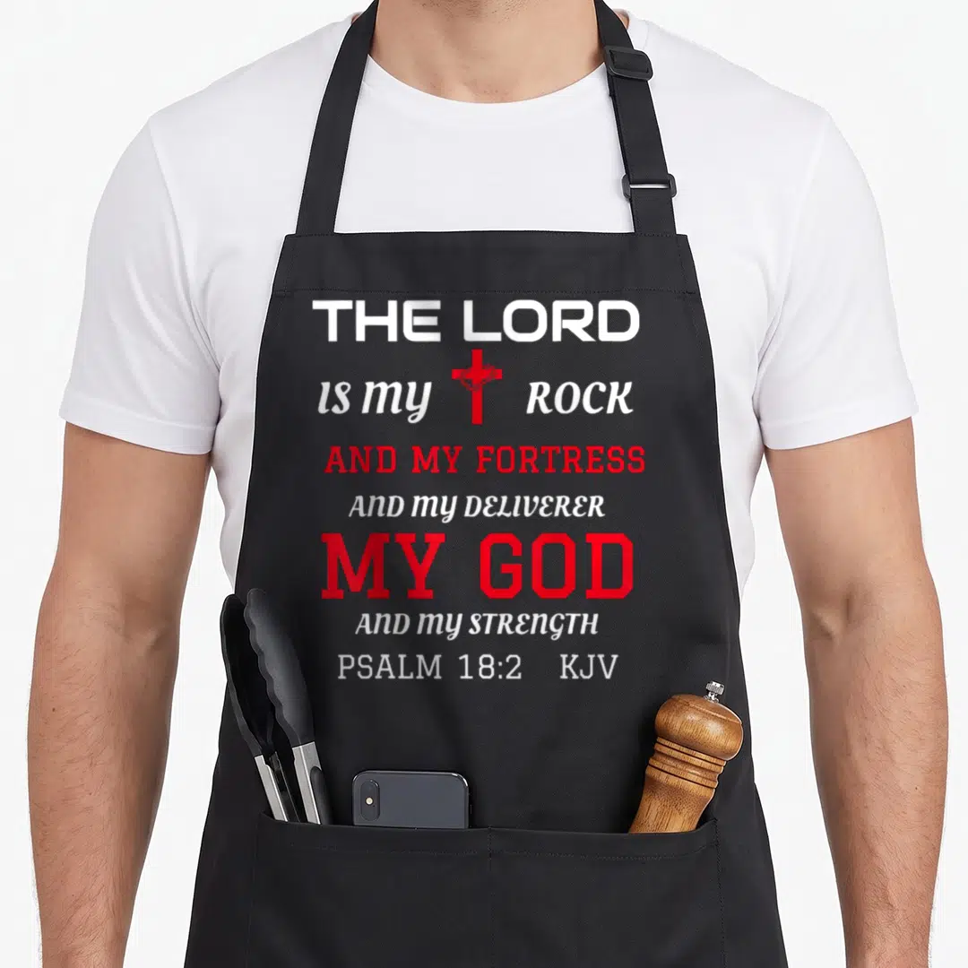 Psalm bible verse apron - Stacked white and red text with red cross and crown of thorns between my and rock — shown on a black cotton canvas apron against a white background