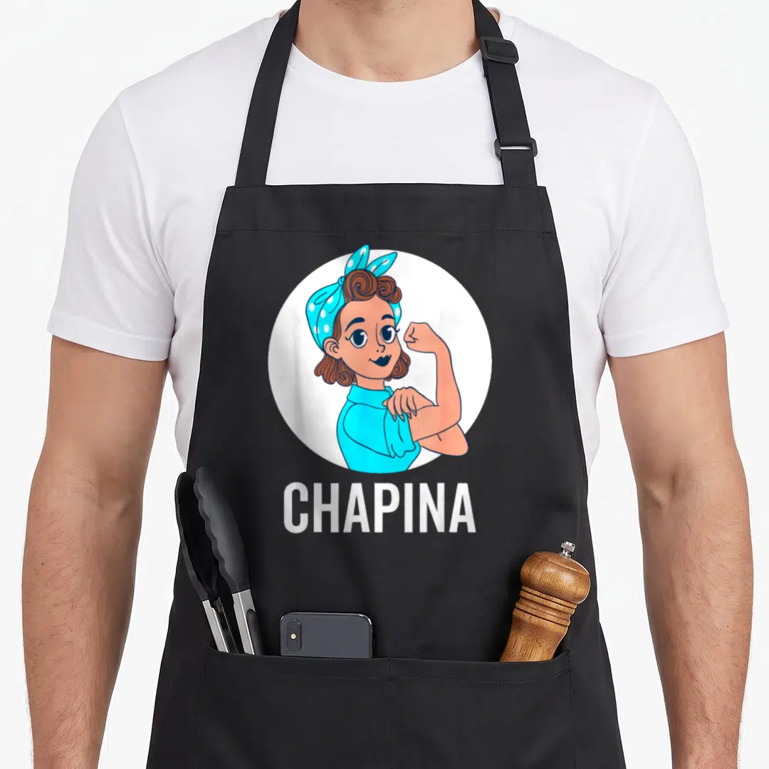 Guatemala flag guatemalan aprons - Cartoon woman flexing muscle in blue headscarf with CHAPINA text below white circle — shown on a black cotton canvas apron against a white background