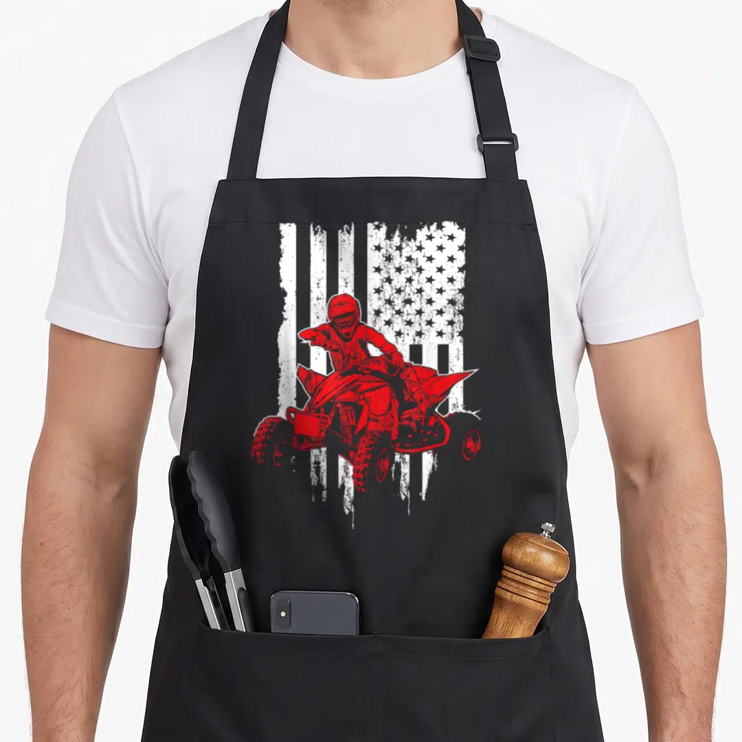 Terrain american flag apron - Red ATV rider silhouette on distressed white USA flag pattern — shown on a black cotton canvas apron against a white background