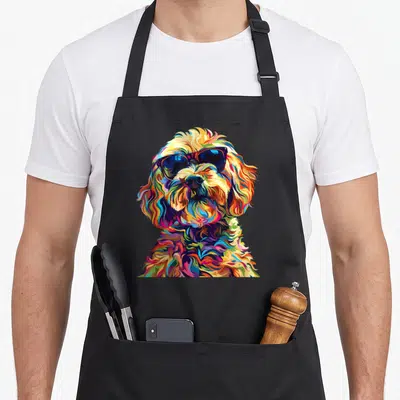 Pop cockapoo apron - Multicolored cartoon cockapoo wearing sunglasses in pop art style — shown on a black cotton canvas apron against a white background