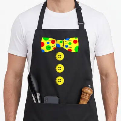 Bow clown aprons - Yellow polka dot bow tie with red blue and green dots above three vertical buttons — shown on a black cotton canvas apron against a white background