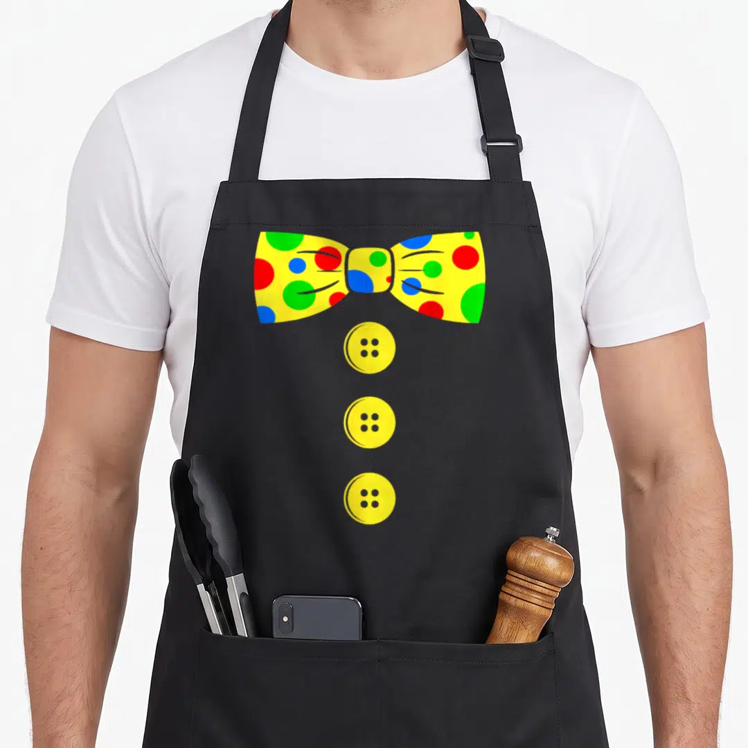 Bow clown aprons - Yellow polka dot bow tie with red blue and green dots above three vertical buttons — shown on a black cotton canvas apron against a white background