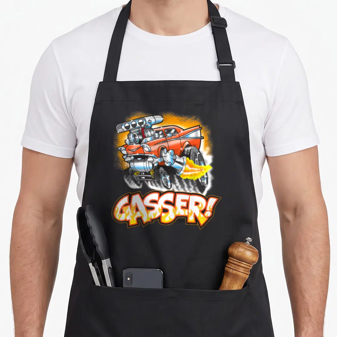 Gasser car apron - Orange hot rod with silver engine and exhaust flames above GASSER! text in white and yellow — shown on a black cotton canvas apron against a white background