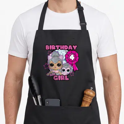 Lol birthday apron - Two dolls inside blue circle with pink ribbon showing number 4, surrounded by stars and BIRTHDAY — shown on a black cotton canvas apron against a white background