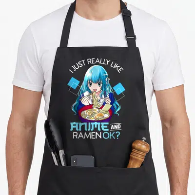 Cute ramen anime apron - Anime girl with blue hair eating ramen under arched text flanked by blue diamonds — shown on a black cotton canvas apron against a white background