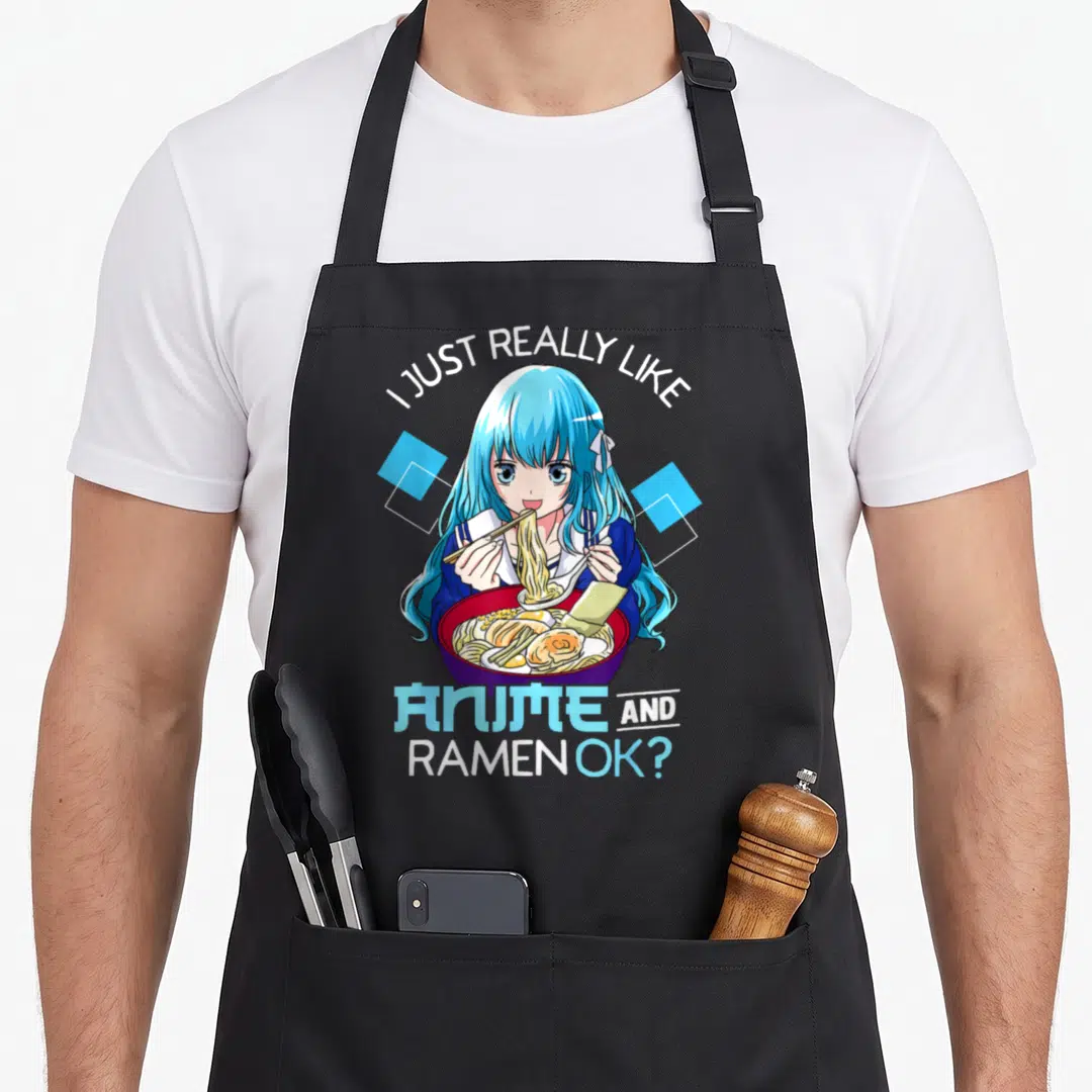 Cute ramen anime apron - Anime girl with blue hair eating ramen under arched text flanked by blue diamonds — shown on a black cotton canvas apron against a white background