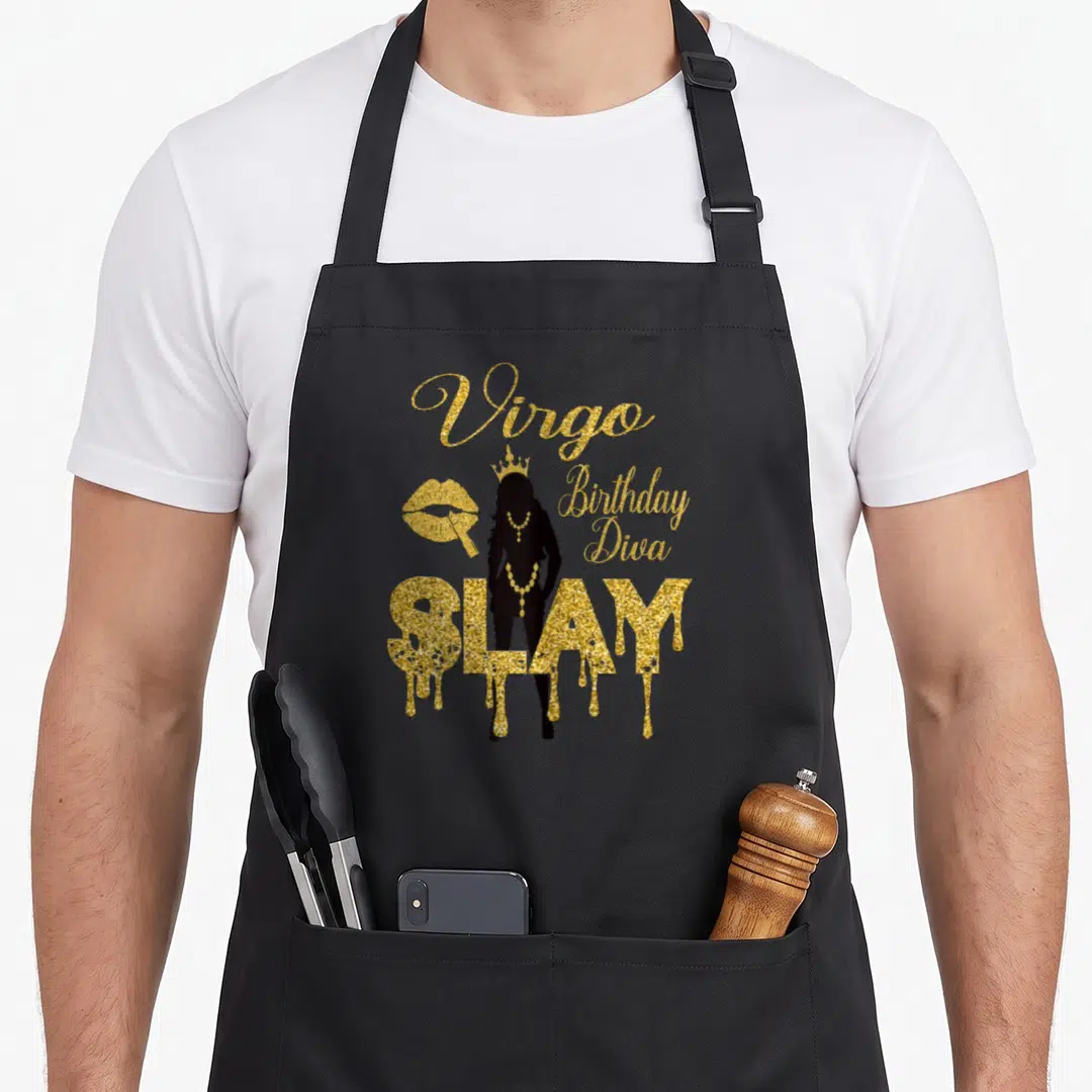 Virgo diva birthday apron - Gold Virgo Birthday Diva SLAY silhouette with lips and dripping text on black — shown on a black cotton canvas apron against a white background