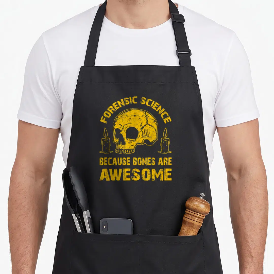 Forensic science apron - Yellow distressed skull with candles and text because bones are awesome — shown on a black cotton canvas apron against a white background