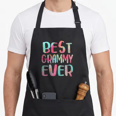 Funny mother grammy apron - Best Grammy Ever text in pink blue orange and green watercolor font — shown on a black cotton canvas apron against a white background
