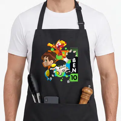 Ben novelty apron - Ben 10 cartoon art with boy, heat creature, four-armed alien, and stacked text — shown on a black cotton canvas apron against a white background