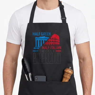 Pride italian apron - Blue Greek temple and red Colosseum split diagonally with text Half Greek Half Italian Equals — shown on a black cotton canvas apron against a white background