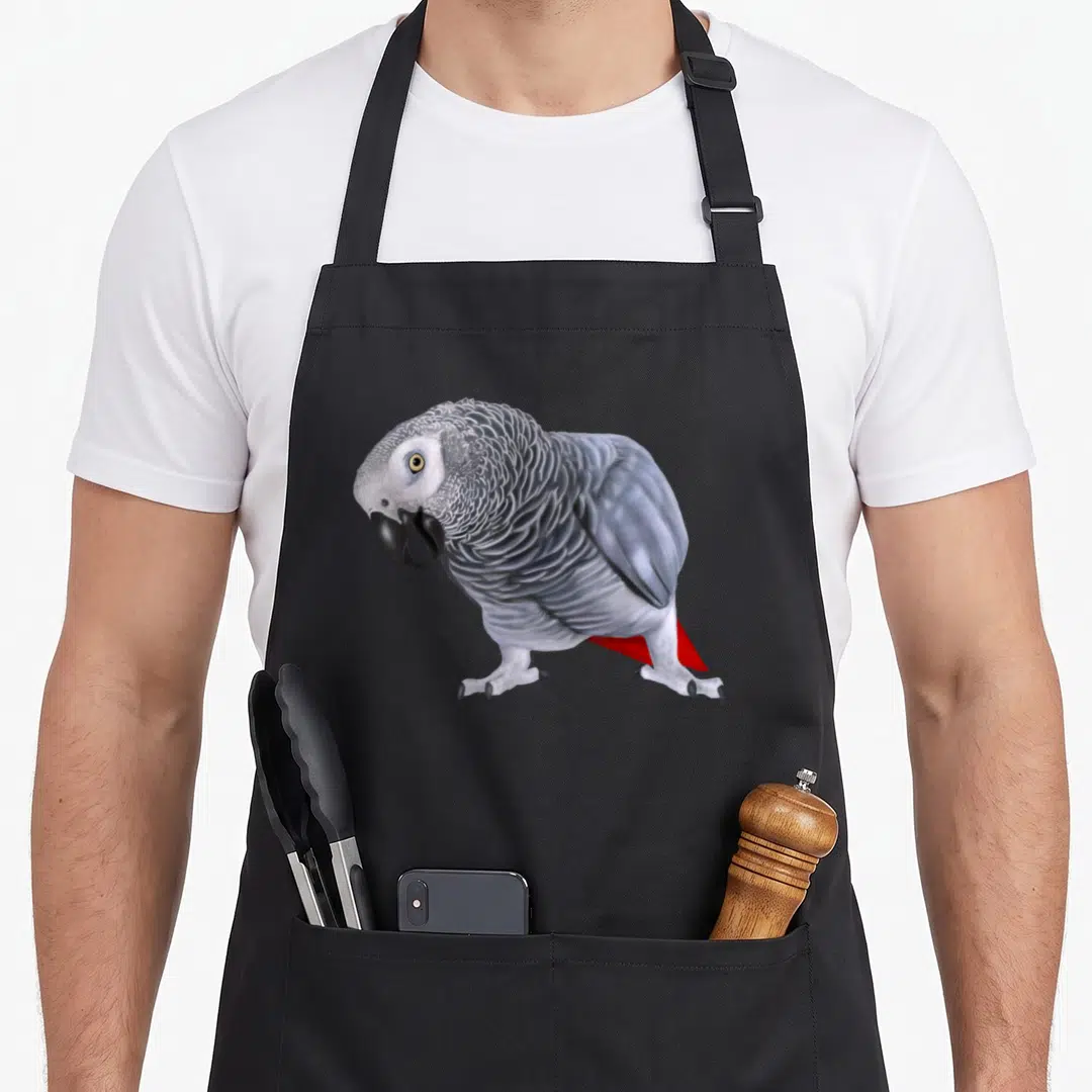 Bird african aprons - Realistic African Grey Parrot illustration in grey, white, and red feathers — shown on a black cotton canvas apron against a white background