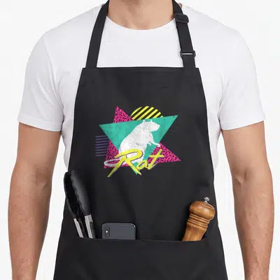 Rat 80s apron - White rat silhouette over teal triangle and pink shapes with yellow Rat script — shown on a black cotton canvas apron against a white background