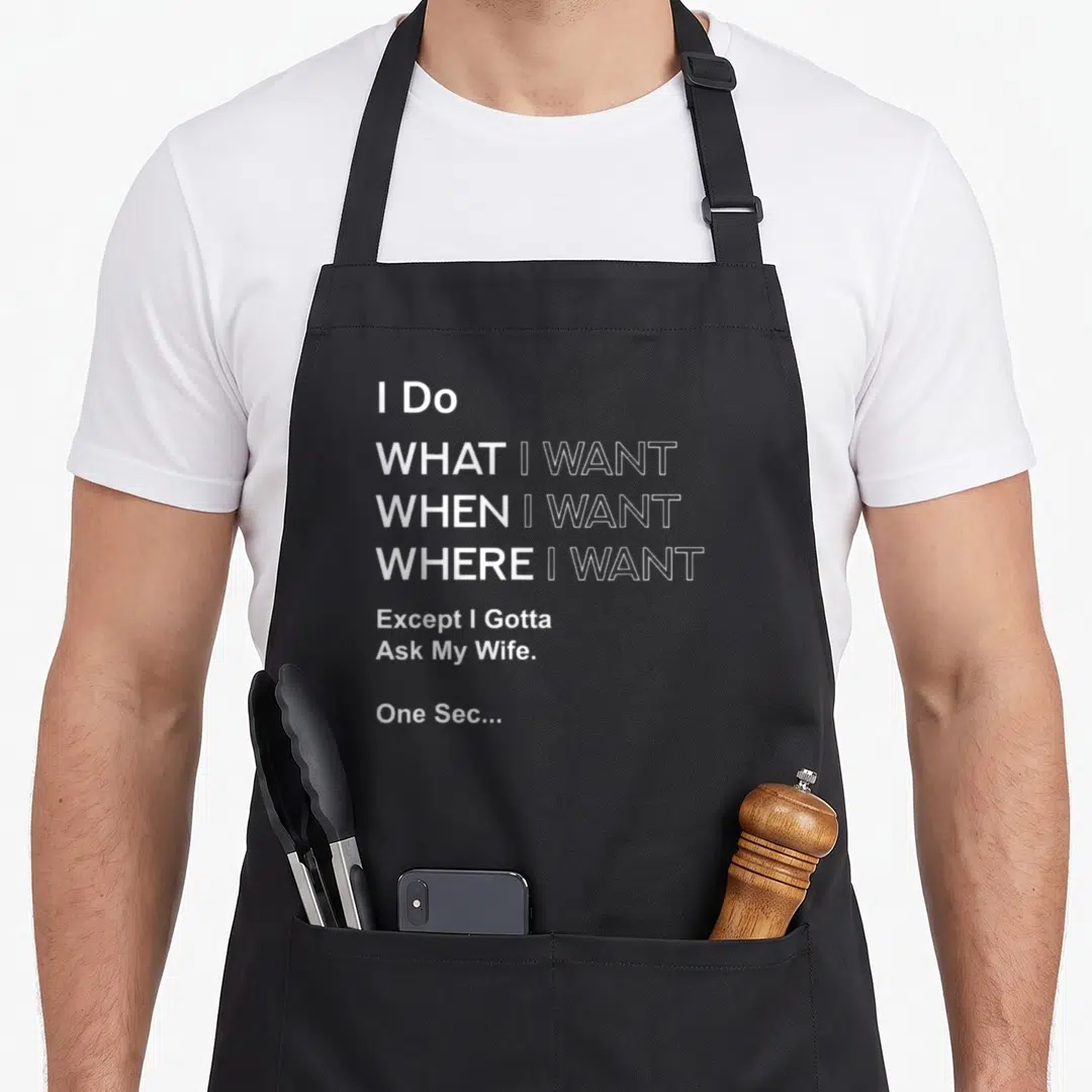 Except wife apron - White stacked text reading I Do What I Want Except I Gotta Ask My Wife One Sec — shown on a black cotton canvas apron against a white background