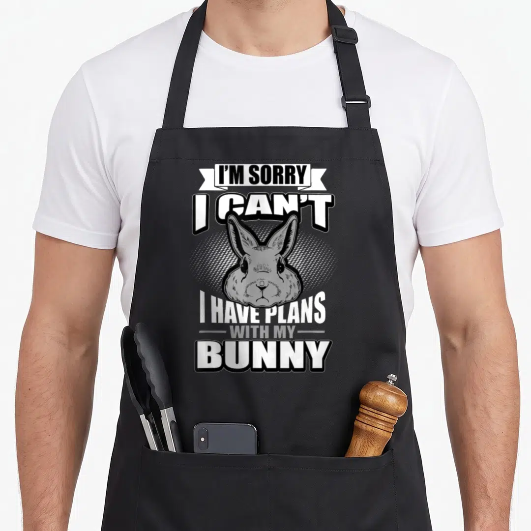 Sorry bunny apron - Stacked text I'm sorry I can't with plans with my bunny around grey rabbit head on dotted background — shown on a black cotton canvas apron against a white background