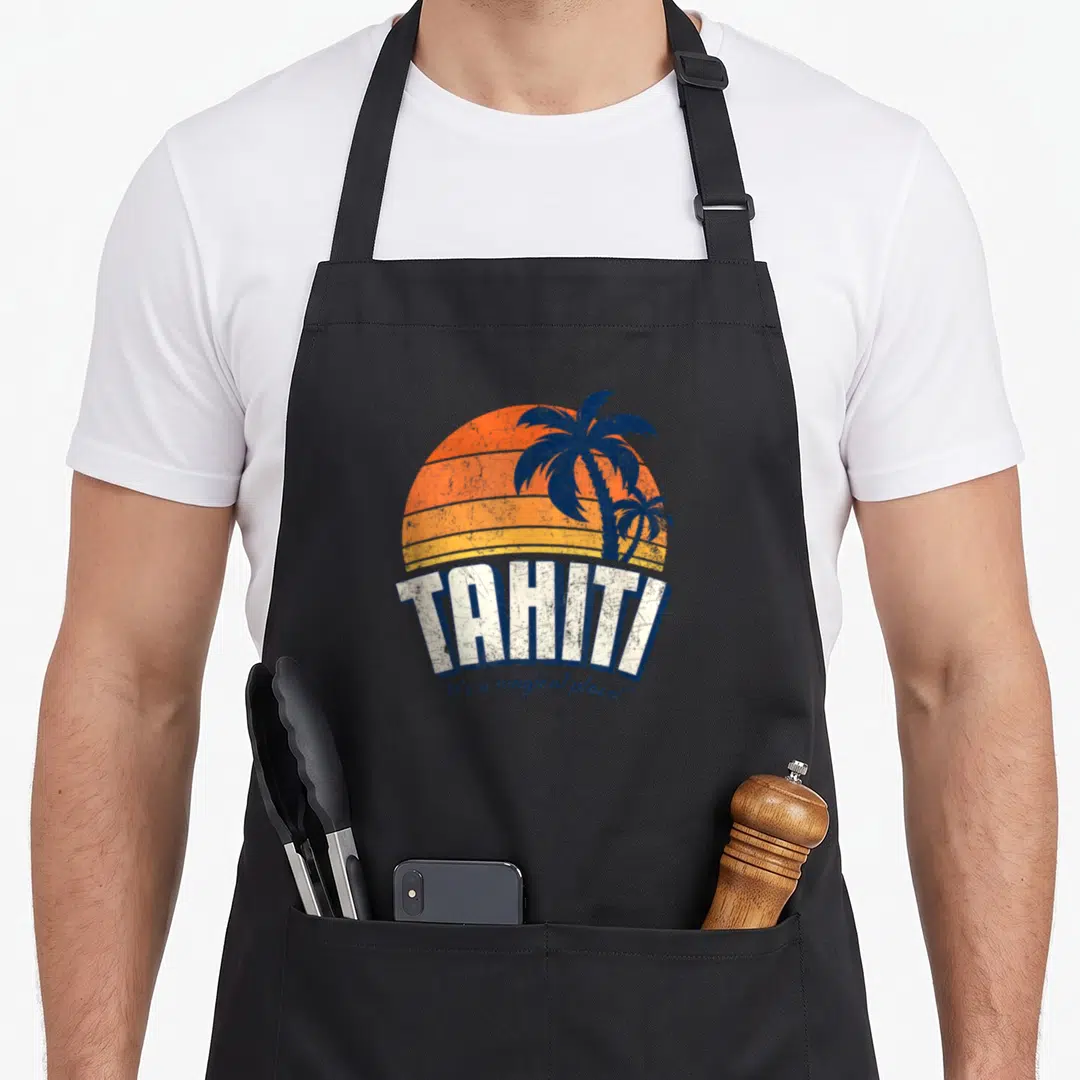 Agent h apron - Retro tahiti sunset with two blue palm trees and white block lettering — shown on a black cotton canvas apron against a white background