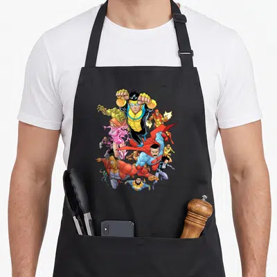 Funny universe apron - Superhero cluster in yellow blue red pink cartoon style action poses — shown on a black cotton canvas apron against a white background
