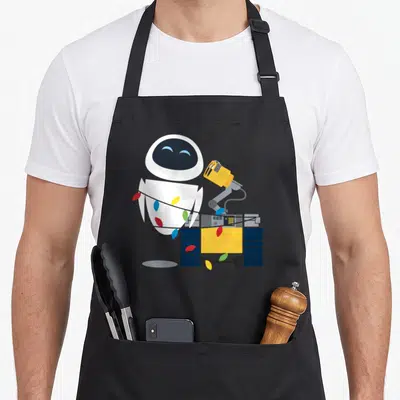 Wrap christmas lights apron - White and yellow robot tangled in red blue and yellow Christmas lights with a black plug — shown on a black cotton canvas apron against a white background