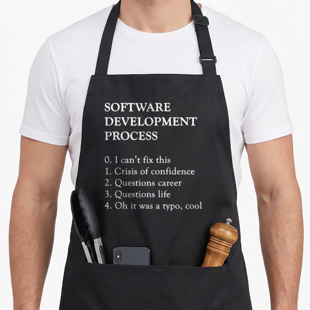 Software programming apron - White text listing software development process steps from crisis to typo realization — shown on a black cotton canvas apron against a white background