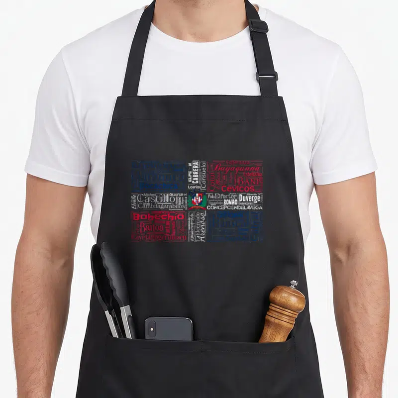 Ciudade i love dominican apron - Typography map of Dominican Republic with city names in blue red and white and central — shown on a black cotton canvas apron against a white background