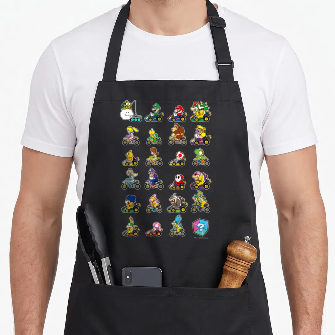 Stack character aprons - Grid of 21 cartoon kart racers in yellow red blue and green with a question mark block — shown on a black cotton canvas apron against a white background