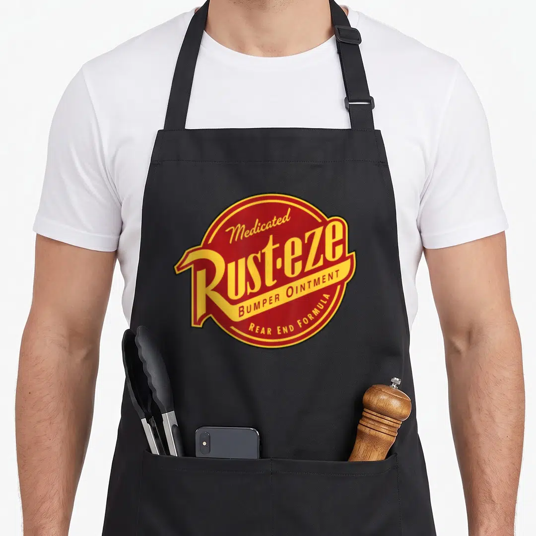 Rust car apron - Red oval logo with yellow text reading Medicated Rust-eze Bumper Ointment Rear End Formula — shown on a black cotton canvas apron against a white background