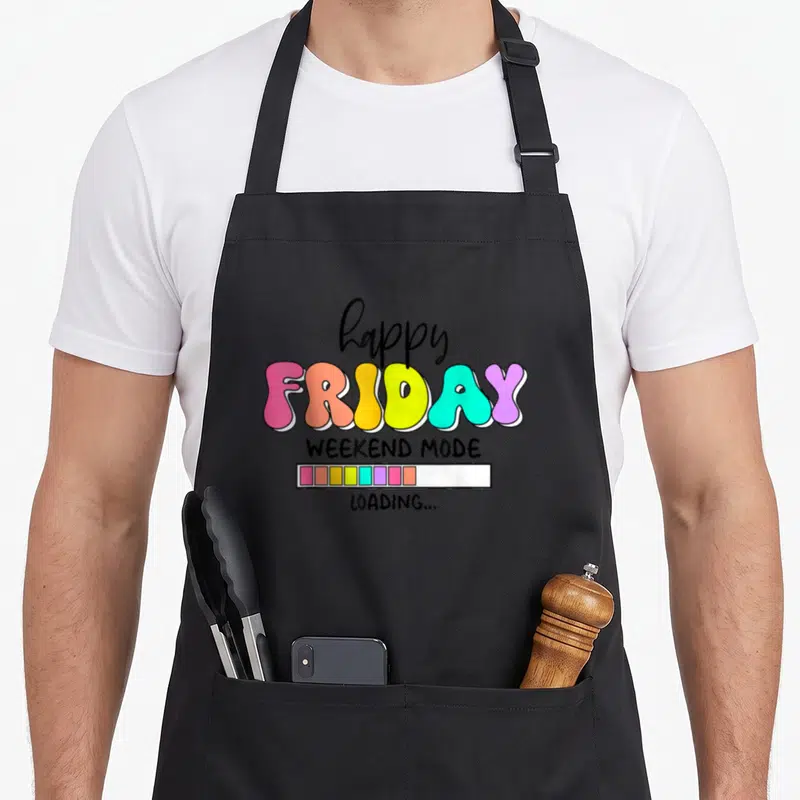 Friyay school teacher apron - Stacked colorful text reading happy FRIDAY WEEKEND MODE LOADING with a segmented progress — shown on a black cotton canvas apron against a white background