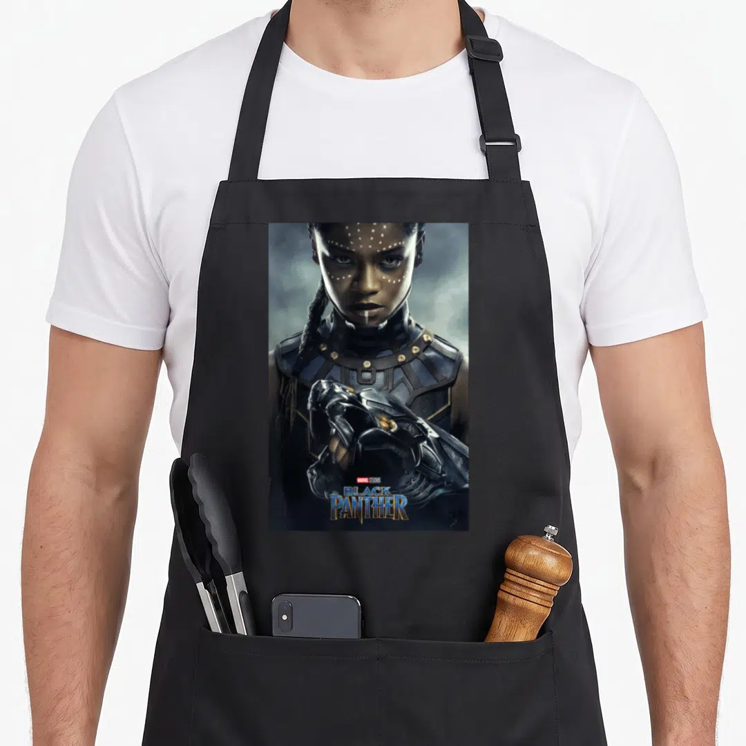 Poster panther apron - Photo of woman in black blue and gold armor with Marvel Studios Black Panther text overlay — shown on a black cotton canvas apron against a white background