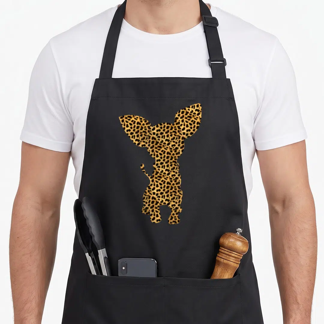 Chihuahua leopard print apron - Dog silhouette filled with brown, black, and tan leopard print pattern — shown on a black cotton canvas apron against a white background