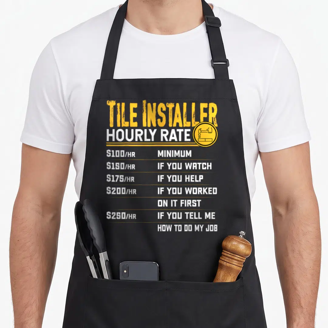 Tile contractors apron - Yellow and white text listing tile installer hourly rates from 100 to 250 dollars — shown on a black cotton canvas apron against a white background