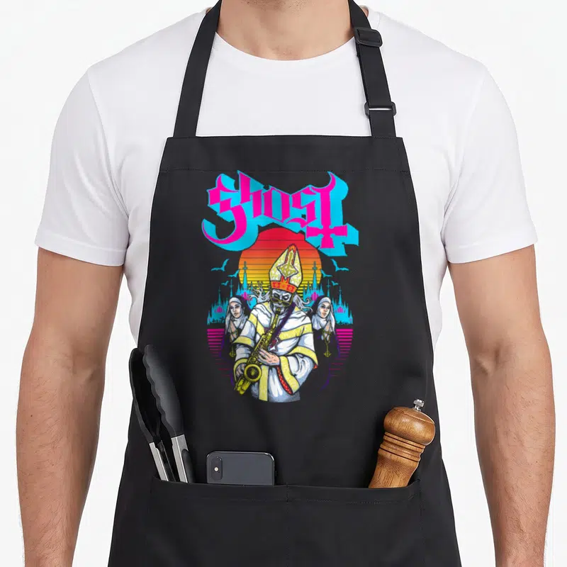 Miasma ghost apron - GHOST text over cartoon pope playing sax with two nuns and red sun — shown on a black cotton canvas apron against a white background