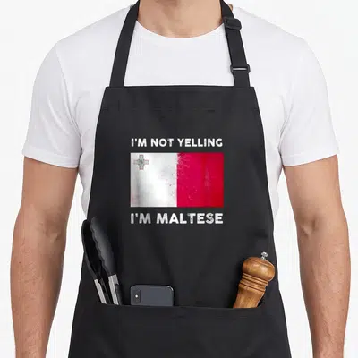 Ich malta apron - Distressed white and red Malta flag between lines of white text on gray background — shown on a black cotton canvas apron against a white background