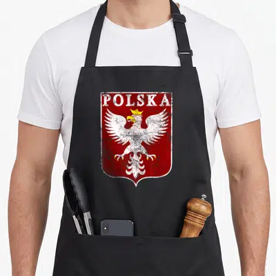 Crest polish aprons - Distressed red shield with white crowned eagle and POLSKA text — shown on a black cotton canvas apron against a white background