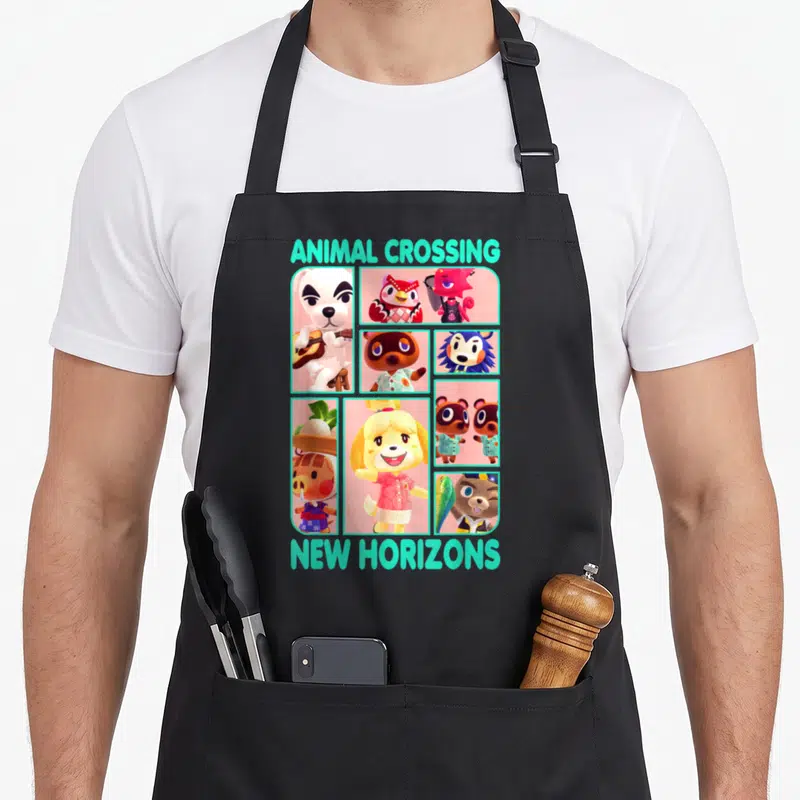Friend animal apron - Animal Crossing New Horizons text above and below a grid of animal characters in cyan and pink — shown on a black cotton canvas apron against a white background