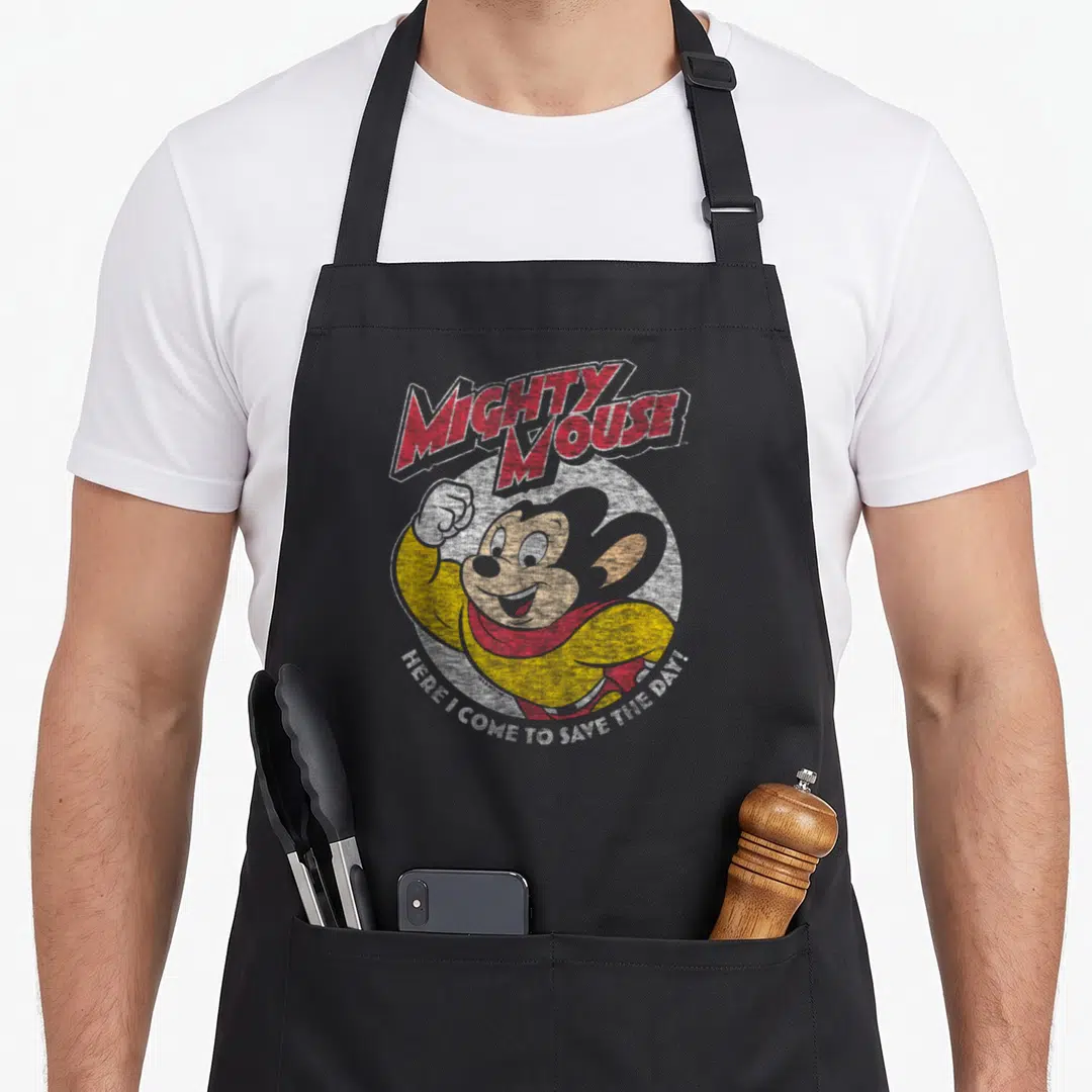 Mighty crazy mouse man apron - Cartoon mouse in yellow suit red scarf white circle red text Mighty Mouse — shown on a black cotton canvas apron against a white background