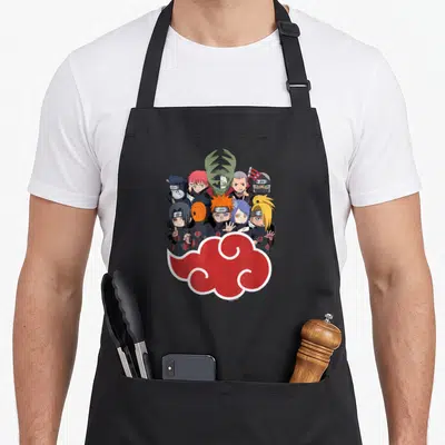 Akasuki anime apron - Ten chibi characters in black cloaks with a red cloud symbol below them — shown on a black cotton canvas apron against a white background