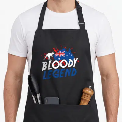 Famous australian apron - Bloody Legend text over blue Australia map with white kangaroo and flag in distressed red — shown on a black cotton canvas apron against a white background