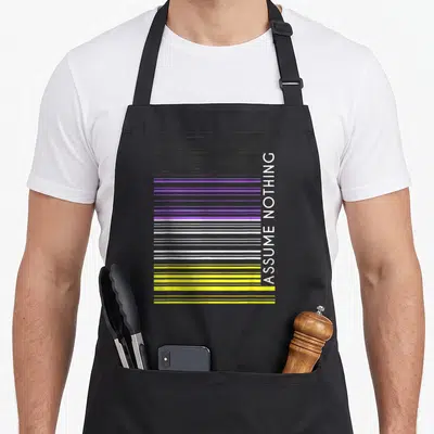 Assume iris apron - Vertical ASSUME NOTHING text beside horizontal black purple white and yellow stripes — shown on a black cotton canvas apron against a white background