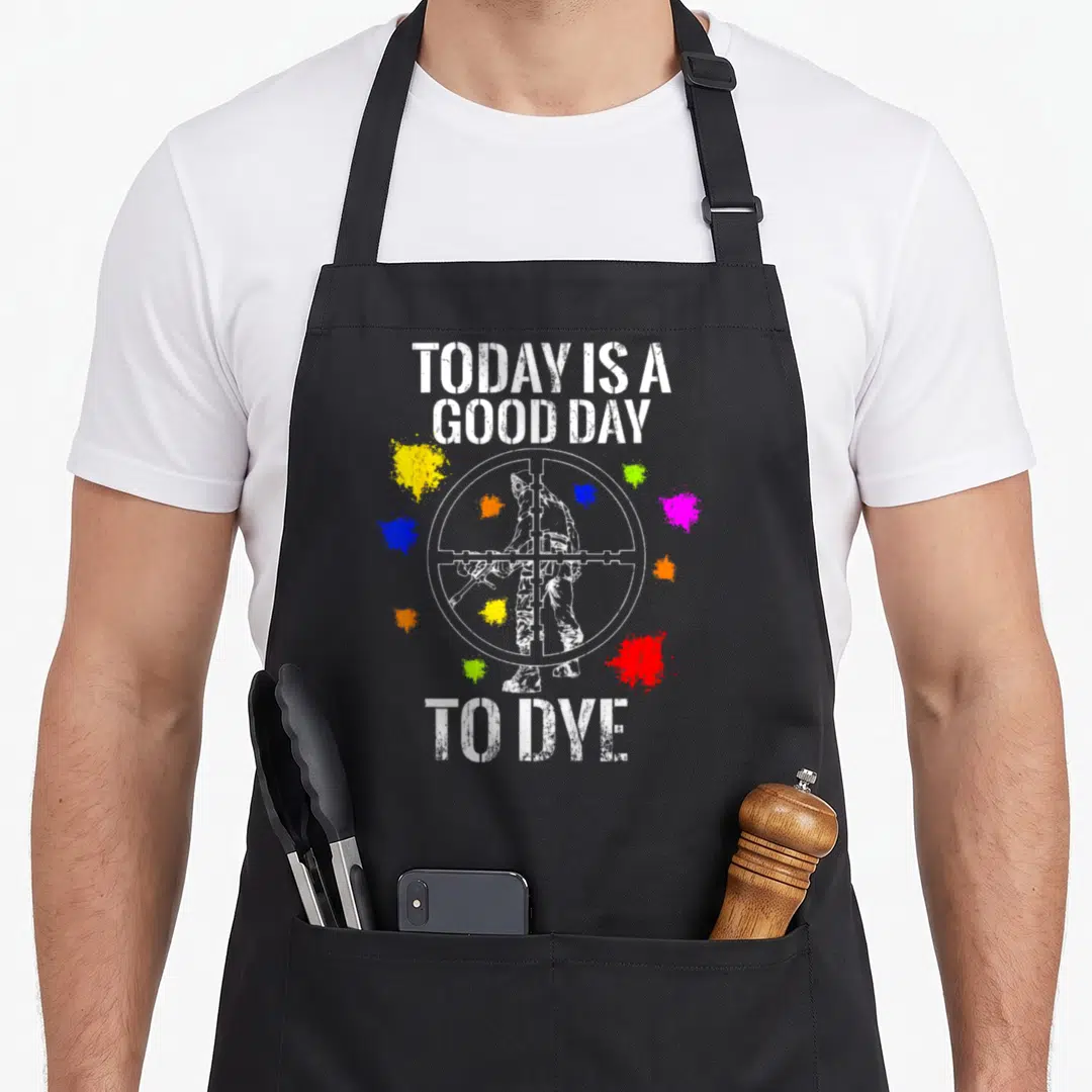Dye paint apron - Crosshair with person silhouette and paint splatters surrounding text TODAY IS A GOOD DAY TO DYE — shown on a black cotton canvas apron against a white background